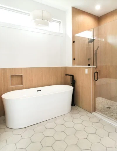 Master bathroom in a whole house renovation in Azle, TX with a free-standing tub and hexagon flooring