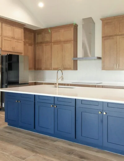 Lake house two-toned kitchen in a whole house remodel in Azle, TX with a blue island