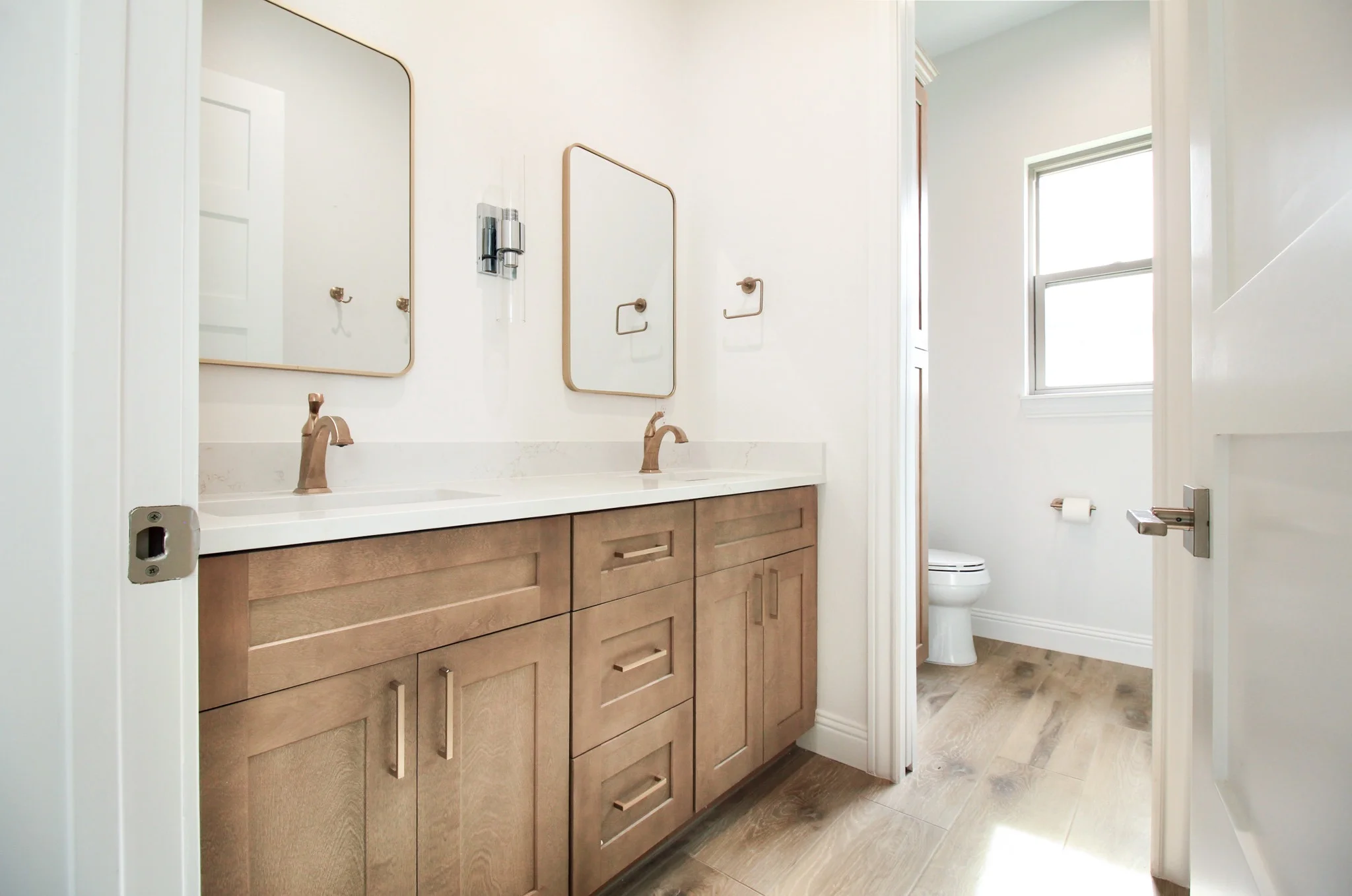 Guest bathroom vanity in a whole house remodel in Azle, TX with gold accents